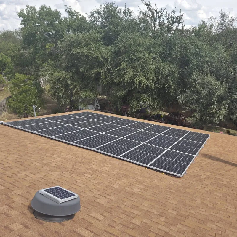 Solar array and a solar attic fan on a new tan shingle roof